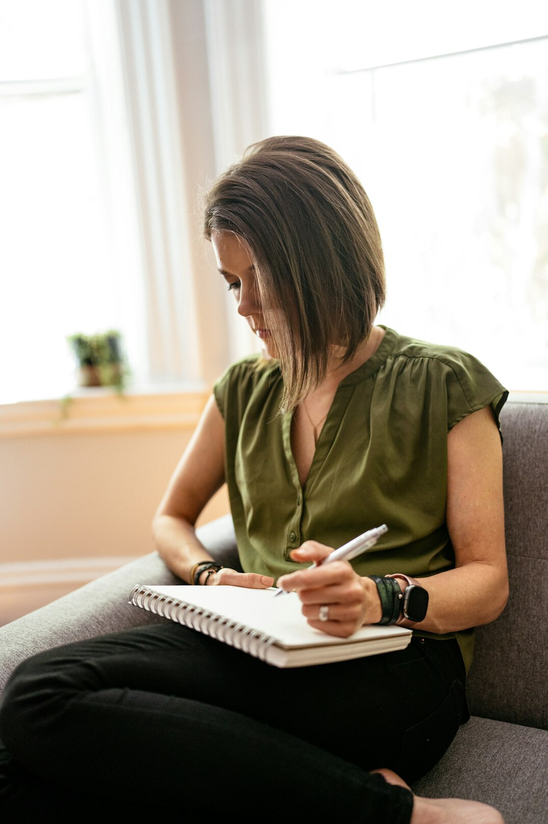 woman writing notes in journal