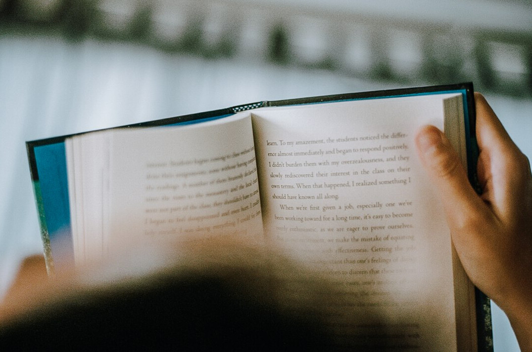 person reading book at home